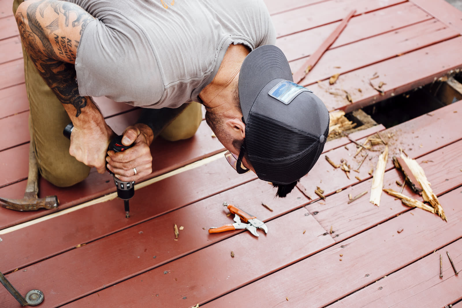 Man repairing wooden decking — the kind of deck, fence & paver work our vetted local pros handle in Sarasota, FL