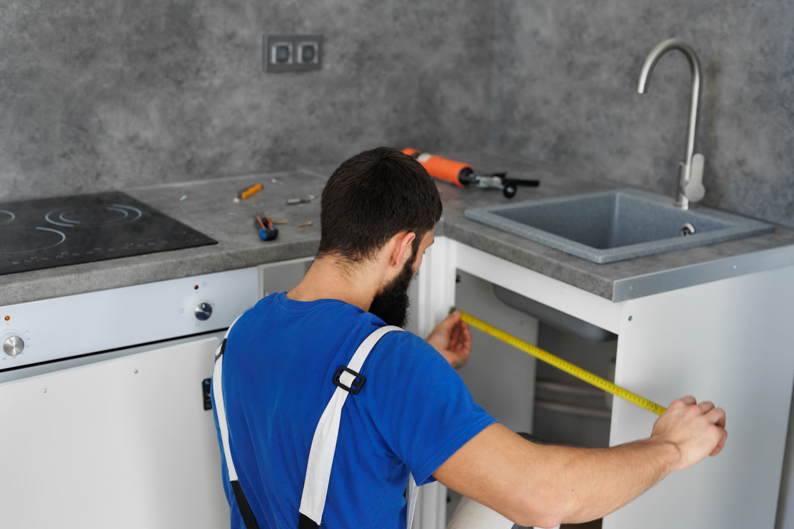 a furniture assembler or builder uses a tape measu — Furniture Assembly in Sarasota, FL