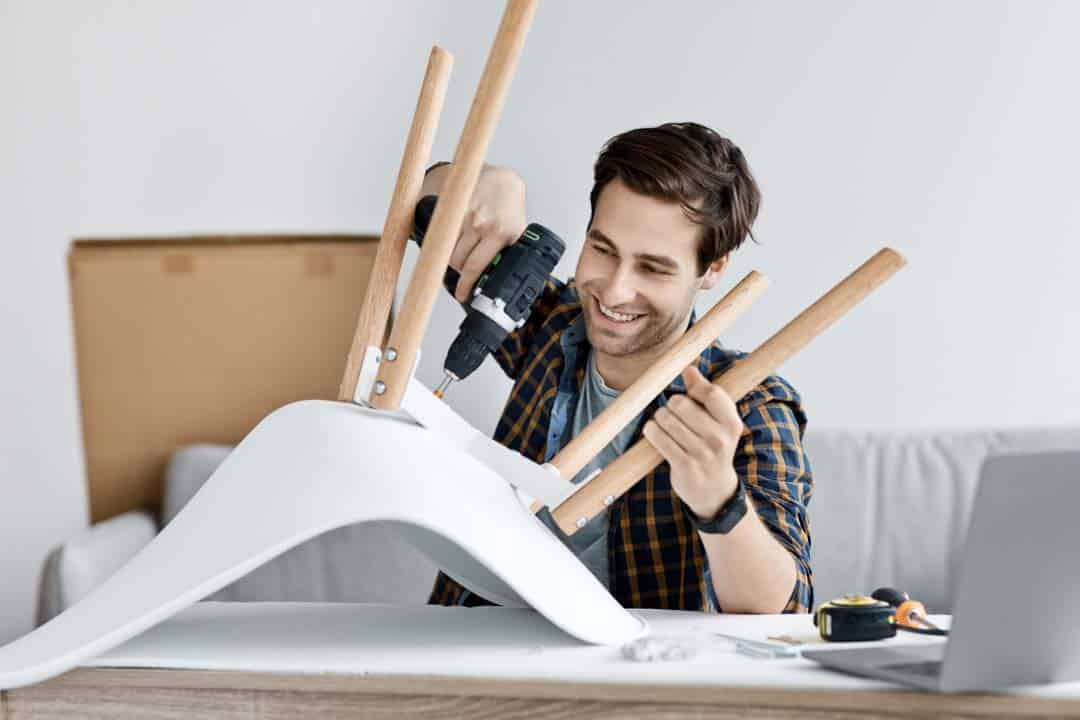Man fixing furniture repairing wooden chair usin — the kind of minor home repairs our vetted local pros handle in Sarasota, FL