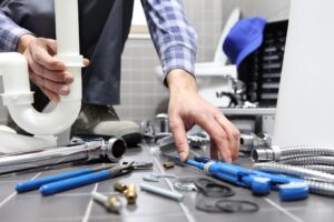 Professional plumber and electrician performing licensed bathroom renovation work safely