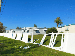 Handyman repairing and reinforcing fence